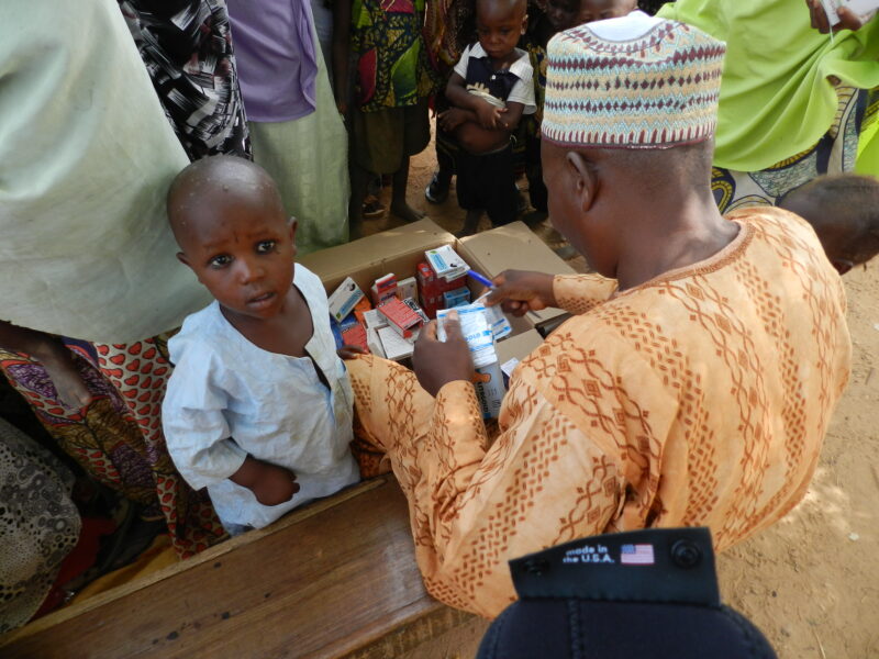 A young child receives antimalarial drugs.